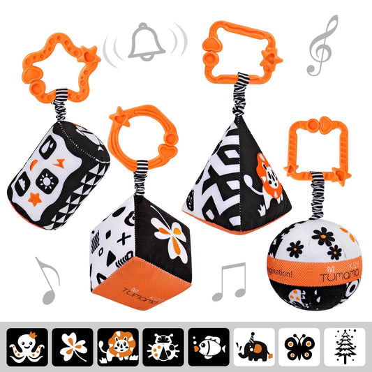 Set of four black and white high-contrast soft baby toys in different shapes (cylinder, ball, pyramid, and cube), each with an orange clip for easy attachment to cribs, strollers, or car seats. Designed to stimulate newborn visual development and sensory exploration.