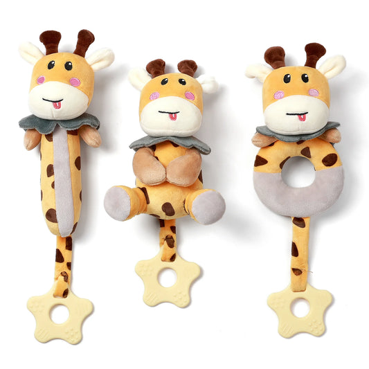 Three plush giraffe baby rattles with soft textures and cheerful faces are displayed side by side. Each giraffe toy has a different design: one is long and cylindrical, one has a round body with arms and legs, and one has a ring-shaped body. All feature beige star-shaped teething rings attached at the bottom, making them suitable for grasping, chewing, and play.