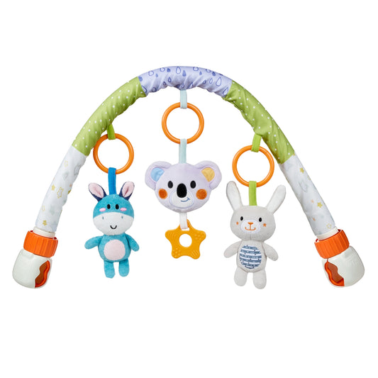 The baby is happily playing with the plush toys on the stroller arch toy