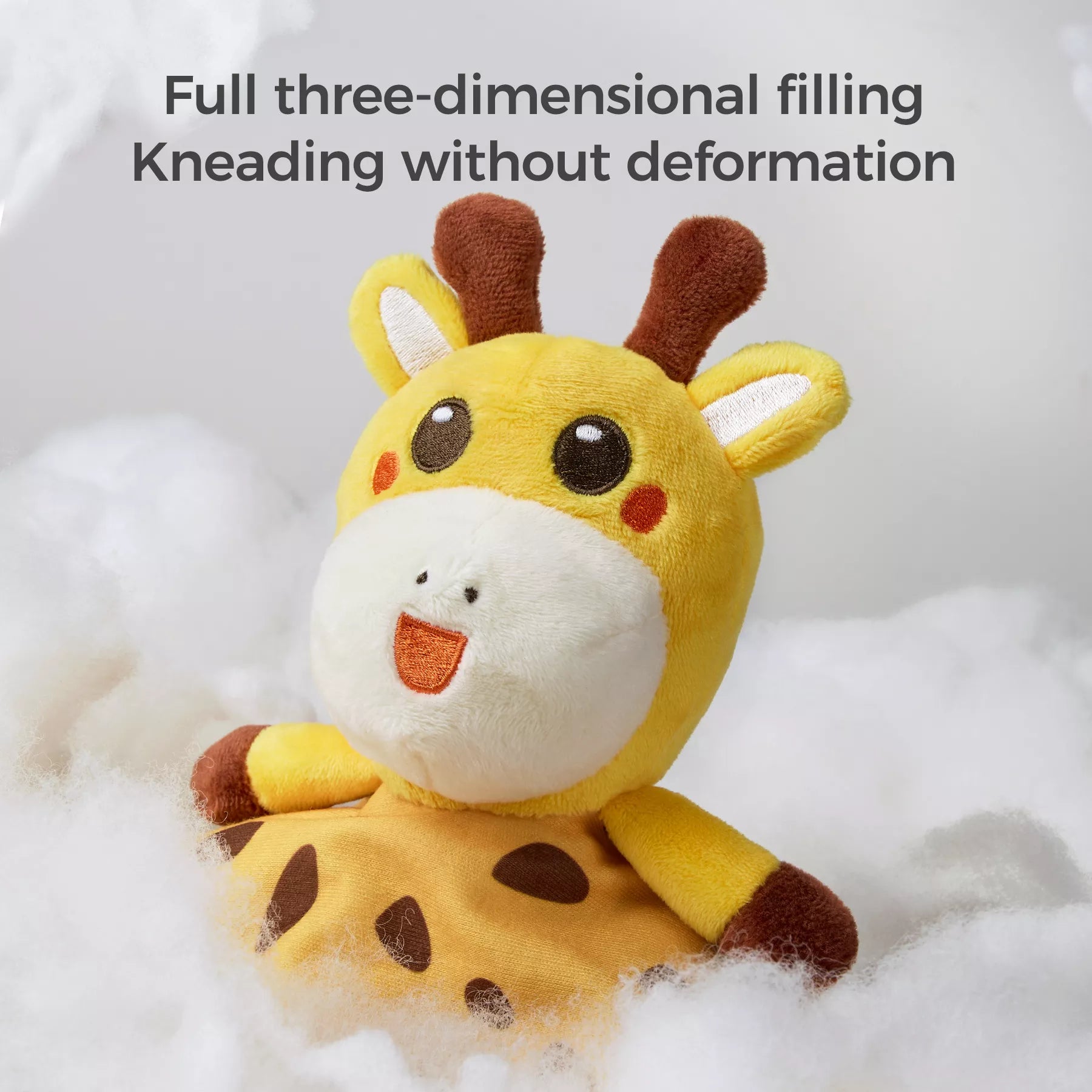 A close-up of a plush giraffe baby security blanket surrounded by soft filling, with the text above saying, "Full three-dimensional filling, Kneading without deformation."