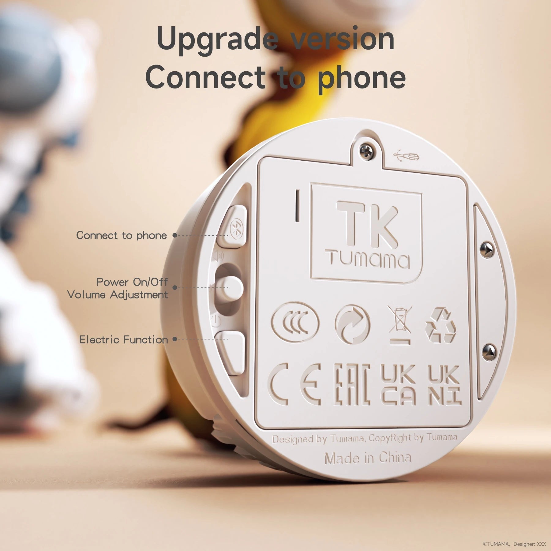 Close-up of the upgraded control module for a plush electric interactive toy by Tumama. The module shows labeled buttons for connecting to a phone, power on/off, volume adjustment, and activating the electric function.