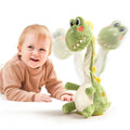 Happy baby in a brown outfit lying on the floor next to a green dinosaur plush electric interactive toy with a rotating neck, shown with motion blur to indicate movement and interaction.