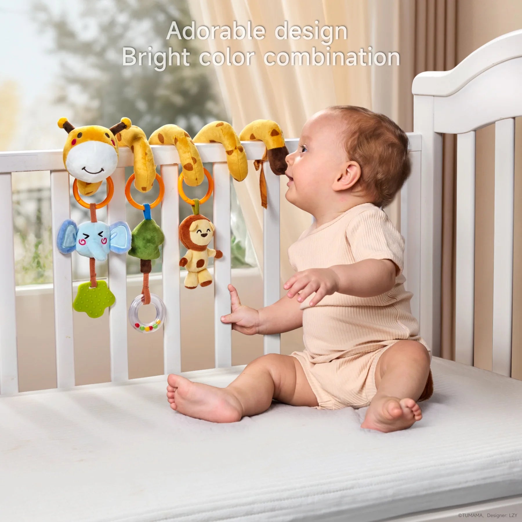 Baby sitting in a white crib, reaching toward a colorful plush spiral toy wrapped around the crib rail, featuring hanging soft figures of an elephant, tree, lion, and giraffe, designed to engage with bright colors and playful design.