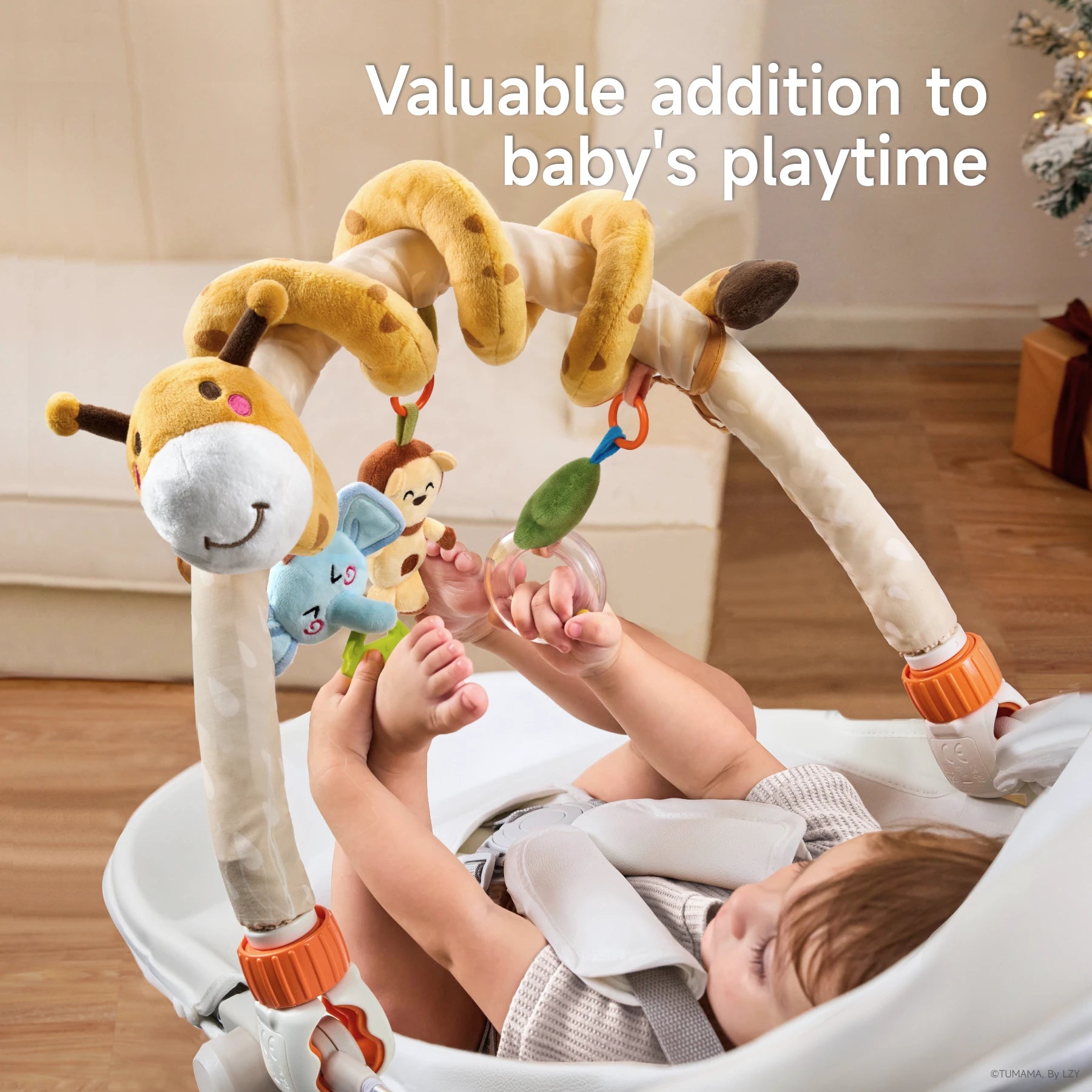 A baby happily touches and plays with a colorful baby arch toy attached to a baby seat. Featuring a plush giraffe, monkey, elephant, and a rattle, the toy offers engaging textures and fun elements. The secure clips keep the arch in place, making it perfect for travel or home use.