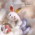 Close-up of a soft spiral bunny toy made from plush, baby-safe materials, resting on cozy fabric. Inset image shows a baby holding and interacting with a plush octopus toy, highlighting its gentle texture and safe design. Ideal for sensory play and comfort.