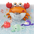 An orange crab-shaped bubble bath toy is attached to the bathtub wall, releasing a stream of bubbles into the water. Around it, three cute wind-up bath toys—a red crab, a green whale, and a purple penguin—float happily among the bubbles. Colorful musical notes are illustrated around the scene, emphasizing fun and music during bath time.