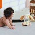 Video of a baby happily playing with the Stuffed Electric Rabbit Bunny Toy on the sofa