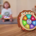 Little-girl-slaps-her-musical-drum-toy